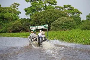 Tours: Boat with tourists looking for jaguar River Cuiaba