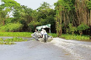 Tours: Boat with tourists looking for jaguar River Cuiaba