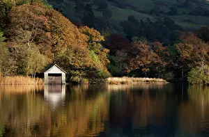 Lakeland: Boathouse reflections in late evening light on