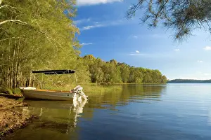 Motorboat: Boating idyll - small motorboat anchors in a tranquil