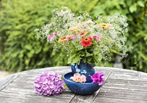 Hydrangea: Bouquet of Zinnias on a garden table in summer