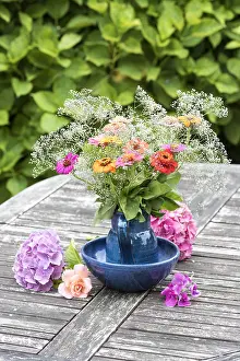 Hydrangea: Bouquet of Zinnias on a garden table in summer