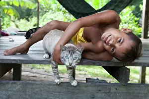 Materials: Boy playing with a cat - Amapa Brazil Amazon