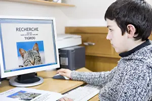 Preparing: Boy preparing a poster to find her lost cat