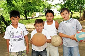 Holds: Boys playing ball, Leon, Nicaragua, Central America