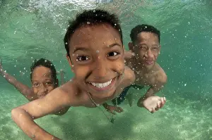 Kids: Boys playing underwater in shallow water
