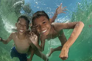 Kids: Boys playing underwater in shallow water