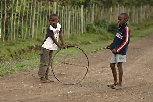 Tribal: boys playing with wheel, near Eldoret, Kenya, Kalenjin
