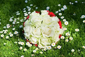 Marriages: Bridal bouquet lying on a flowering meadow