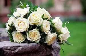 Marriages: Bridal bouquet with white roses on the edge of a