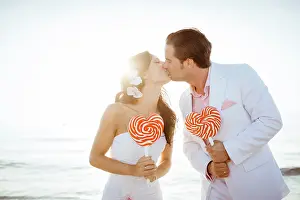 Celebrations: Bride and groom kissing, heart-shaped lollipops