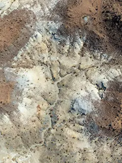 Eroded: Broken, rocky ground with sparse vegetation