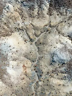 Eroded: Broken, rocky ground with sparse vegetation