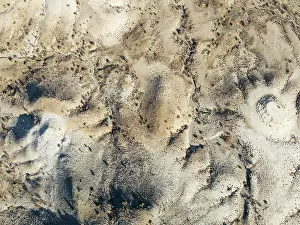 Eroded: Broken, rocky ground with sparse vegetation