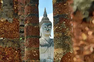 Statues: Buddha Statue between pillars, Wat Sa Si Temple, Sukhothai