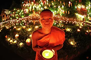 300517: Buddhist Monks at Wat Phan Tao Temple holding candles du