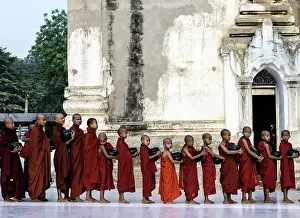 Monks: Buddhist Monks young monks queuing with alms bowls of food