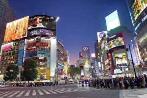 Neon: Buildings around the Shibuya Scramble Crossing at sunset in