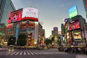 Neon: Buildings around the Shibuya Scramble Crossing at sunset in