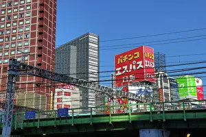 Tracks: Buildings along the skyline of Kabukicho and train tracks in