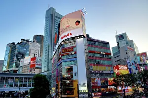 Crossing: Buildings along the skyline of the Shibuya crossing in Shibu