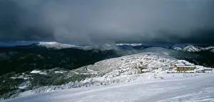 Stirling: Buller Village Alpine Resort under dark storm clouds.from