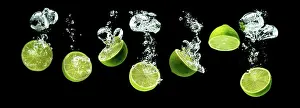 Sinking: Bunch of lime fruits halves sinking with bubbles
