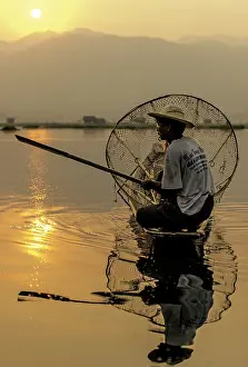 Inle: Burmese Fisherman fishing at dawn