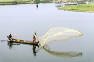 Fishermen: Burmese Fishermen throwing a fishing net