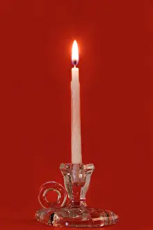 Lifestyle: Burning candle in a glass candle holder