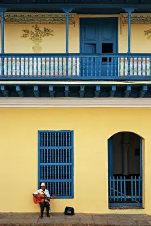 Window: Busker at the restored colonial building of the