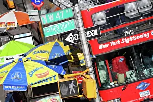 Signs: Busy street scene with red tourist sightseeing bus, stre