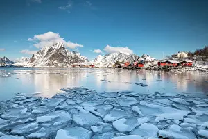 Cabins: Cabins by the fjord with ice floes in the foreground