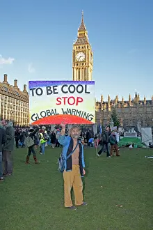 Protest: Campaigner with banner Be cool stop global warming