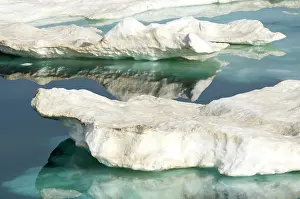 Breaking: Canada, Nunavut. Ice floes cruising Foxe