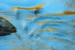 Rippling: Canada, Ontario. Water rippling by a rock
