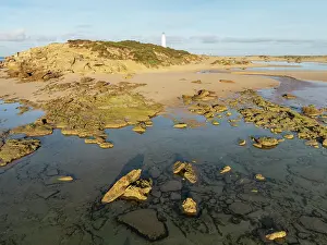Lighthouse: Cape Trafalgar at the Atlantic Ocean at low tide