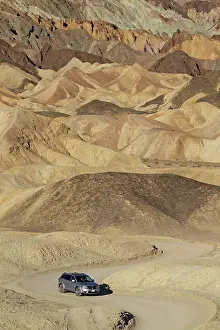 Team: Car on the loop road through the otherwordly badlands