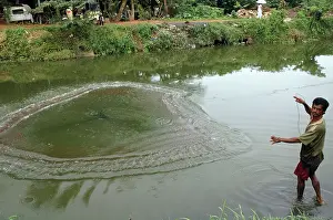 Canals: Cast Net Fisherman fishing in drainage canal
