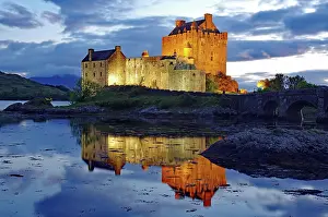 Differently: Castle with bridge is lit differently at dusk, Eilean