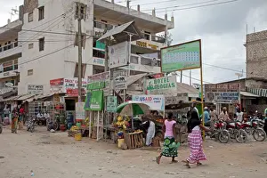 Motorcycle: Casual street scene with market stalls advertising