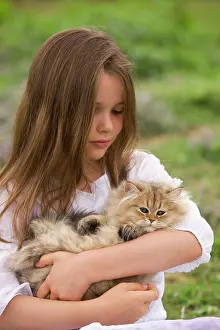 Choosing: Cat - 8 week old kitten being held by young girl
