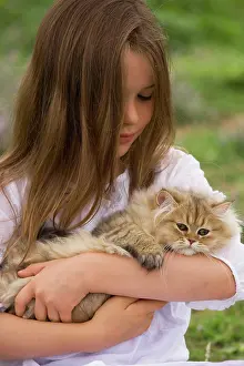 Choosing: Cat - 8 week old kitten being held by young girl