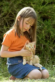 Choosing: Cat - girl holding ginger kitten