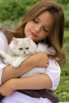 Choosing: Cat - kitten being held by young girl