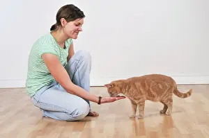 Treat: Cat - owner offering cat a treat in hand
