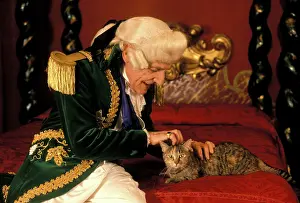 Stroking: Cat - on four poster bed being stroked by man in