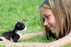 Choosing: Cat - young black & white kitten with girl