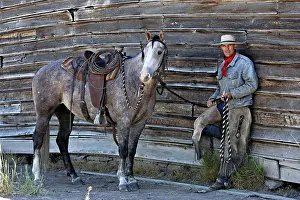 Ranches: Cattleman standing with Quarter / Paint Horse