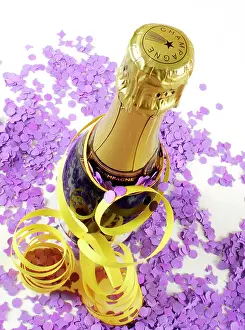 Celebrations: Champagne bottle with streamers and confetti